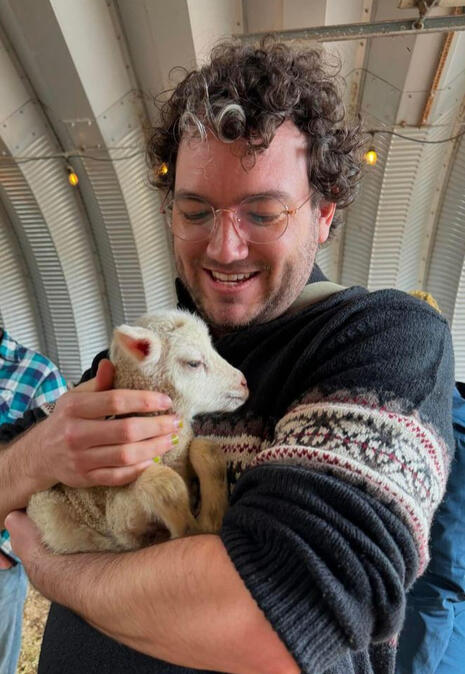 Christian holding a baby sheep